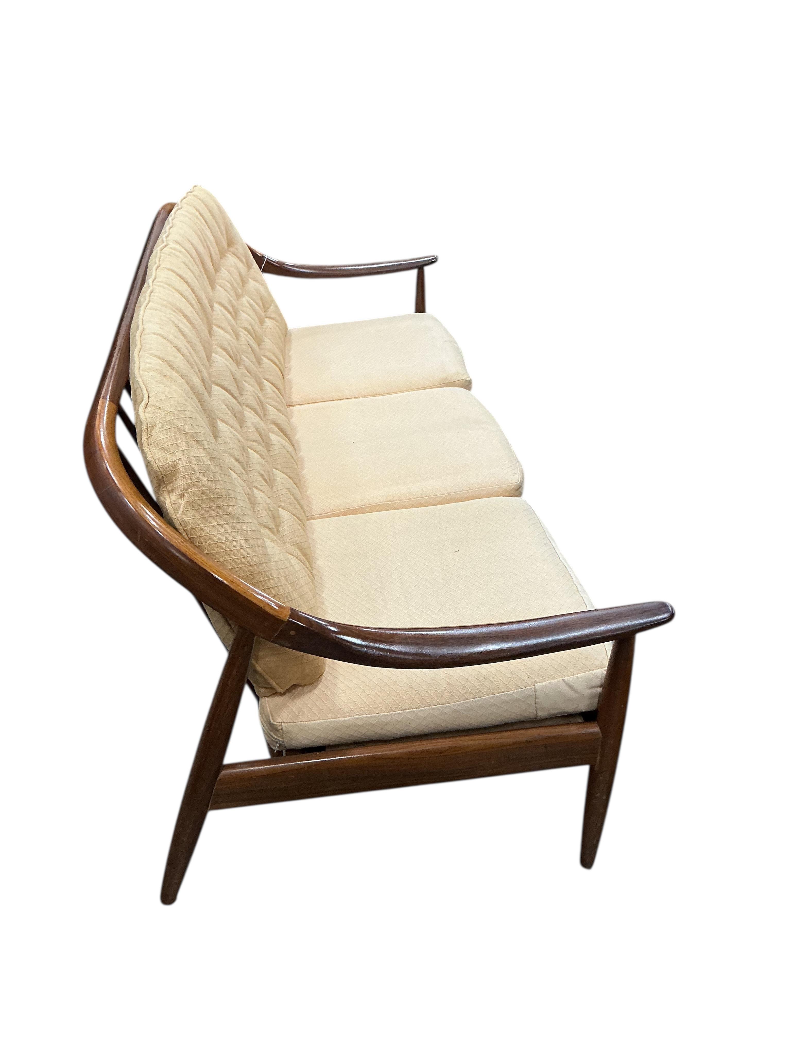 Greaves and Thomas: A mid century teak stick back sofa, width 168cm, depth 70cm, height 70cm